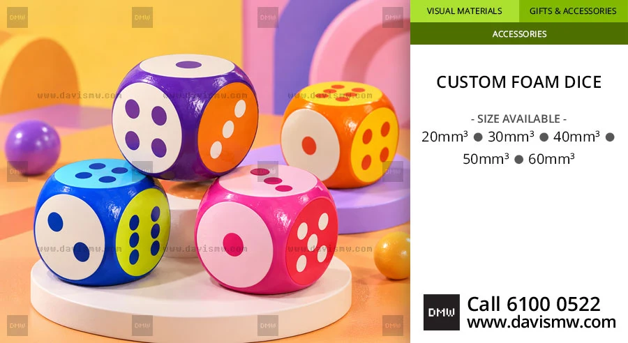 Four colourful foam dice in purple, orange, blue and pink with white dots
